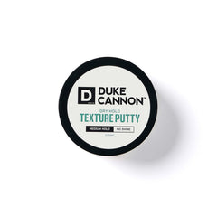 Model with styled hair using Duke Cannon putty showing natural matte hold