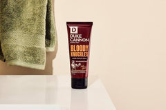 Duke Cannon tube in a hand to show travel-size convenience and portability