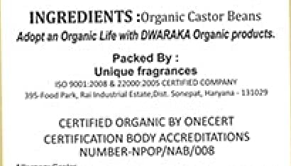DWARAKA castor oil 500ml bottle held in hands to show scale and practical size