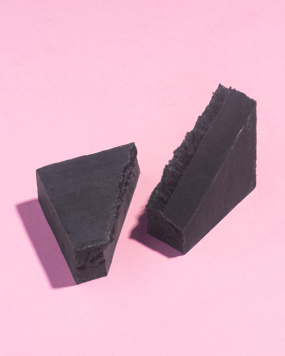 Earth Harbor close-up texture of charcoal soap revealing gritty cleansing particles