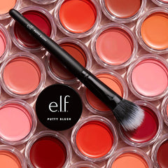 e.l.f. putty blush Fiji next to hand for size comparison and travel convenience