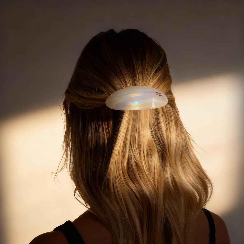 Eliongpu barrette next to a hand for size comparison showing ample coverage benefit