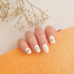 Emifunny stickers beside a finger for scale illustrating fit on small nails