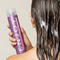 Enjoy conditioner pumped on hand demonstrating rich slip for easier detangling benefit