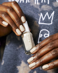essie lifestyle on desk with manicure tools, fast at-home touch-up benefit