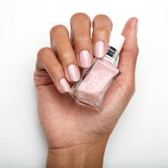 Essie painted nails in lifestyle scene showing salon-quality glossy finish