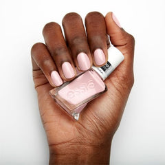 Essie bottle next to coin for scale showing travel-friendly size benefit