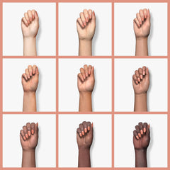 essie swatch on a fingertip displaying creamy camel finish and wearable sophistication