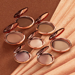 Estée Lauder compact beside coin to show scale and travel-friendly 0.74 ounce size