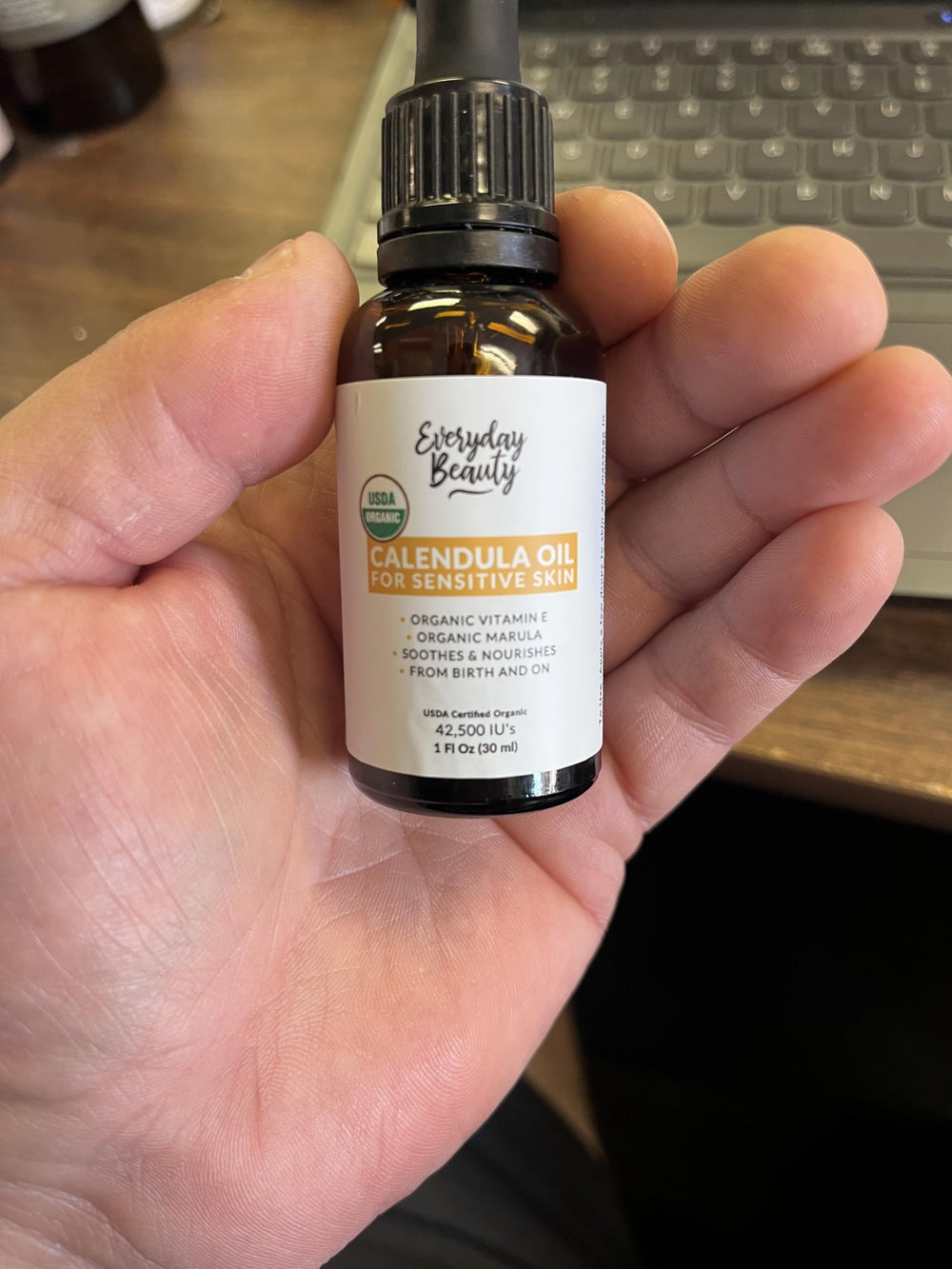Everyday Beauty applying oil to elbow to soothe dry patches and maintain moisture