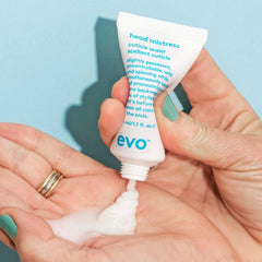 EVO Head Mistress held in hand to show 1 fl oz size and portability