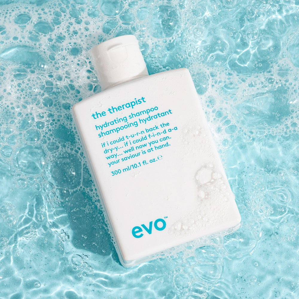 Person using EVO shampoo in shower illustrating smoother hair and manageability benefit