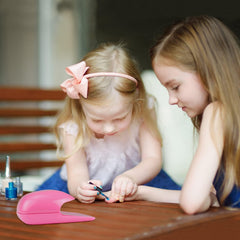 eyxformula in use with child holding dryer for faster, less-smudged polish