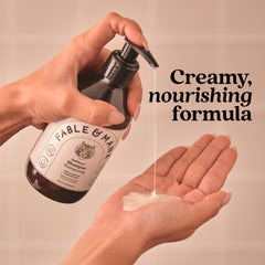 Fable & Mane bottle held by hand showing product size and portability