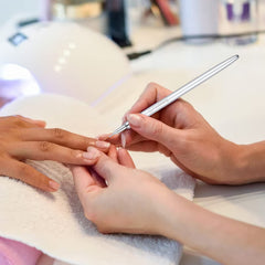 Fadoleng brushes on a nail art station with finished nails showcasing professional results