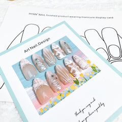 FDSQHSA nails worn on hands in beach setting showcasing finished manicure