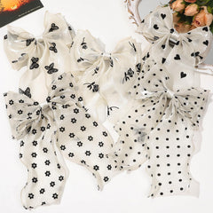 FidesAmor bow clipped in ponytail adding movement and vintage charm