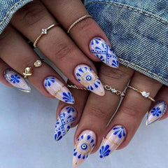 FJSMTOPl close-up of blue boho almond nail designs highlighting style details