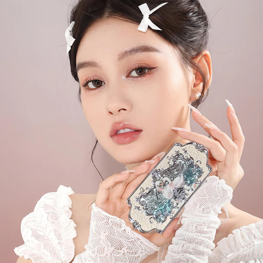 Flower Knows engraved swan and skirt detail highlighting decorative compact art