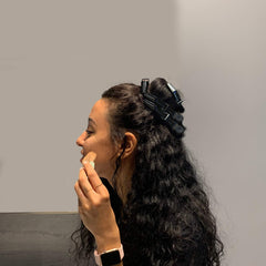 FRAMAR clips held in stylist hands demonstrating easy one-handed use