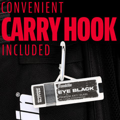 Franklin Sports eye black stick next to glove showing compact travel size