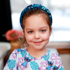 FROG SAC child wearing headband, keeping hair back and adding colorful flair