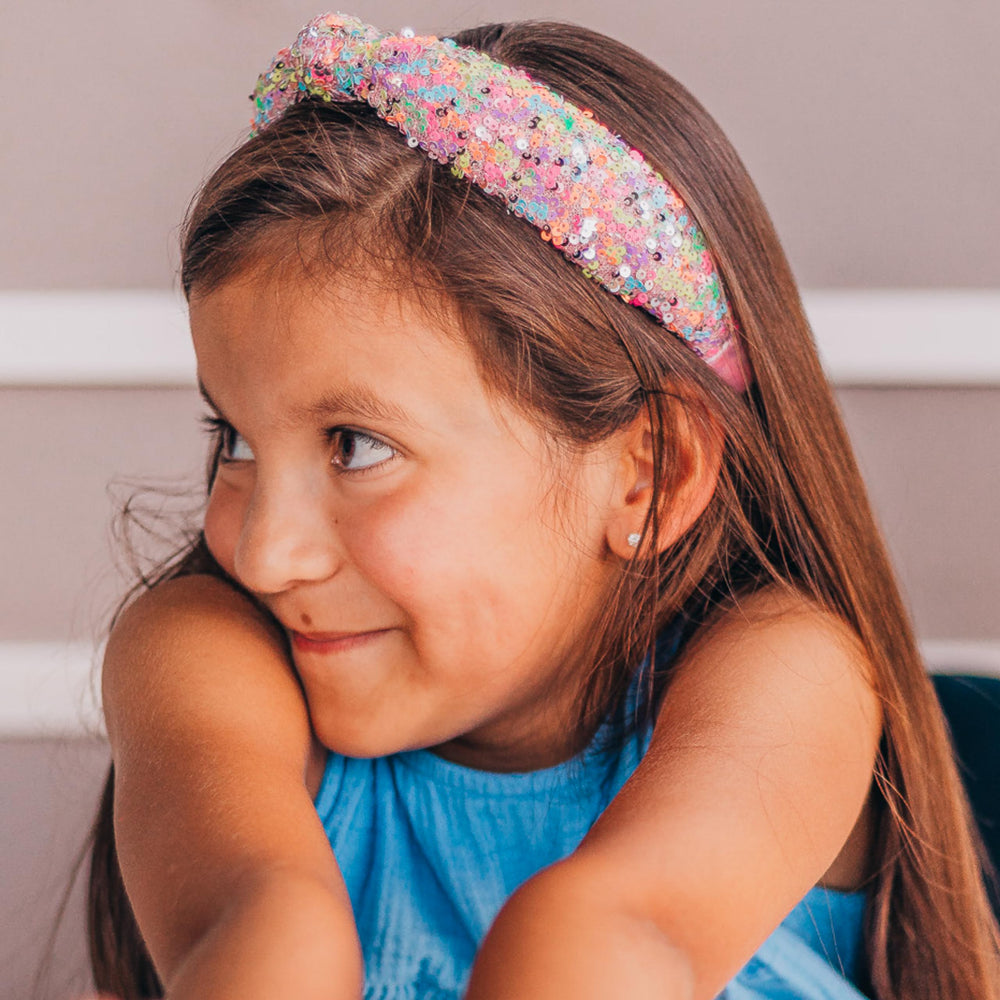 Child wearing FROG SAC headband at school showing secure hold and playful style