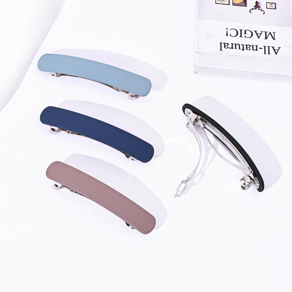 Fsmiling black and tan barrettes displayed together offering versatile color options