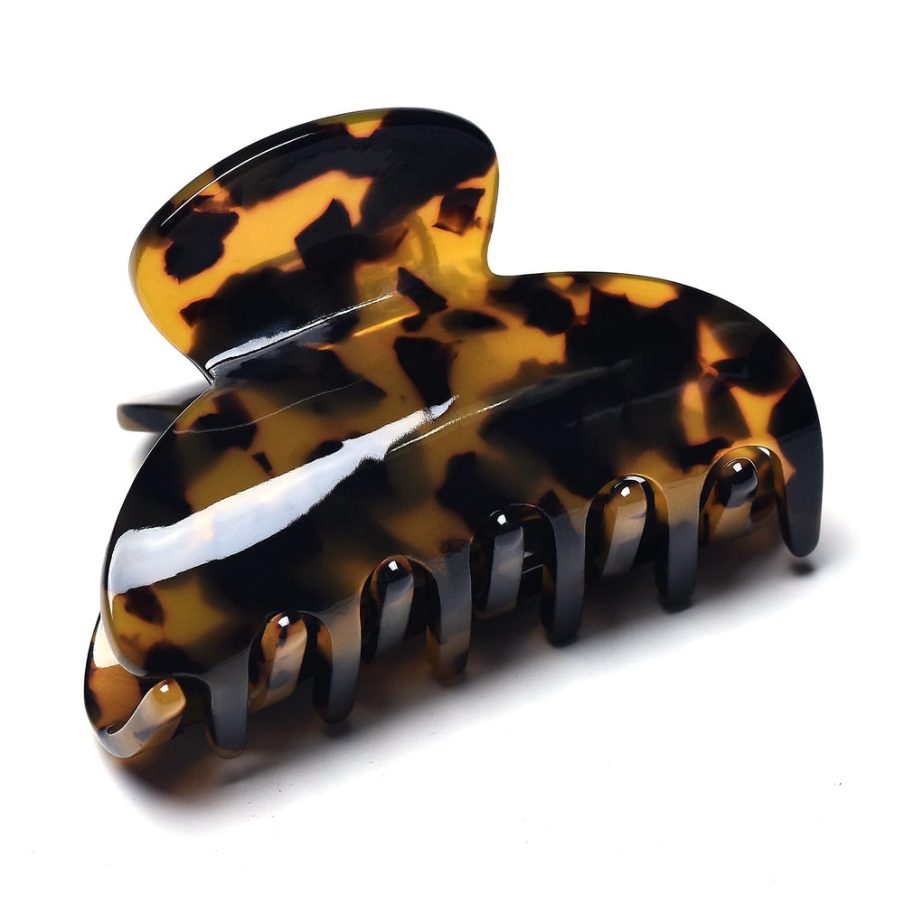 Fsmiling clip securing a low bun for comfortable all-day wear