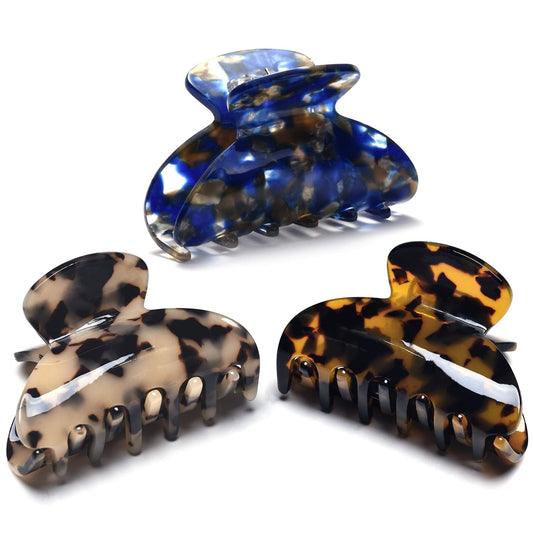 Fsmiling front view of three tortoise claw clips showing pattern and size benefit