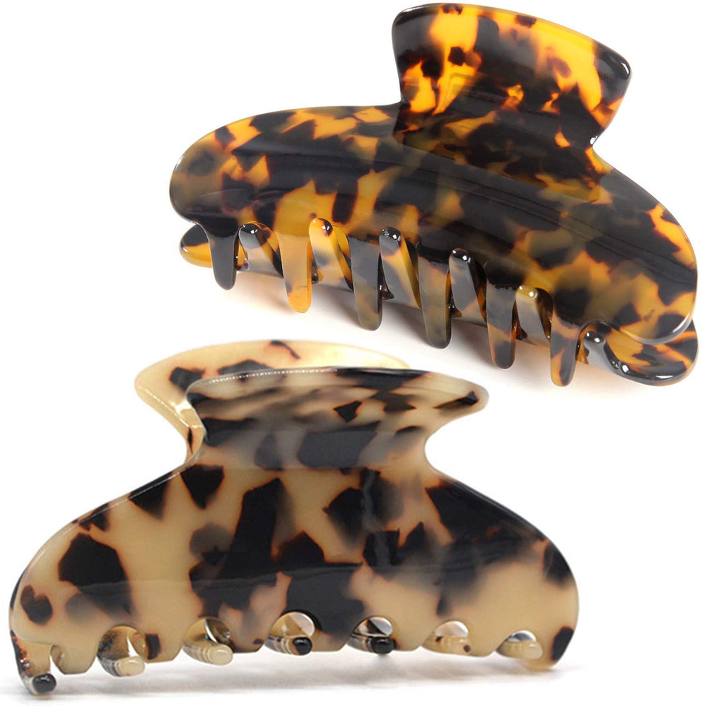 Fsmiling front view of two tortoise claw clips showing pattern and compact shape for styling