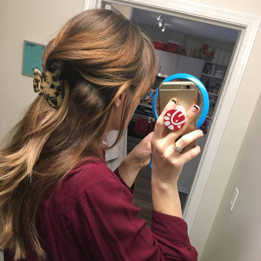 Fsmiling half-up hairstyle held by clip demonstrating easy everyday styling