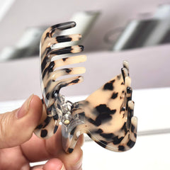 Fsmiling comparison of tortoise and leopard prints for styling choices