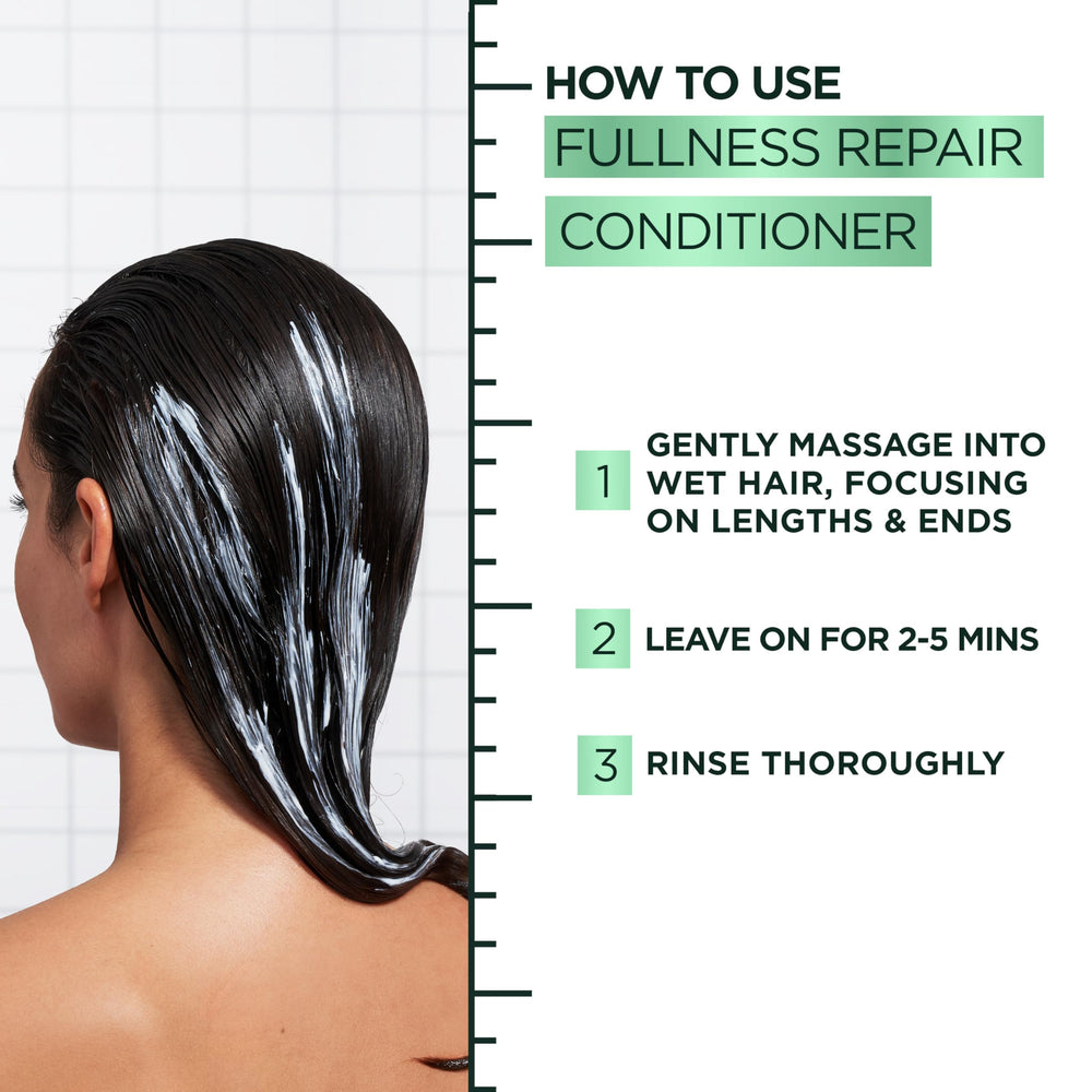 Garnier woman styling hair post-use for fuller, voluminous results
