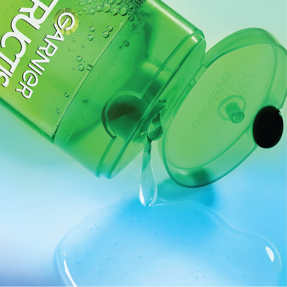 Garnier Fructis size comparison next to hand showing large bottle