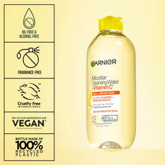 Garnier bottle next to common items to show 400 mL travel-friendly size