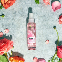 Garnier model spritzing mist to refresh skin and revive makeup quickly