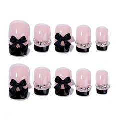 Generic close-up of bow rhinestone detail on nail, highlighting decorative sparkle and polish