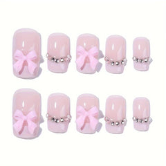 Generic close-up of rhinestone and bow detail on nail, adds sparkle and charm