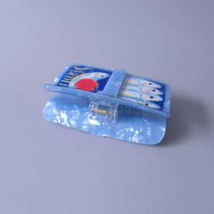 Generic sardine can clip size comparison in hand showing compact travel-friendly benefit