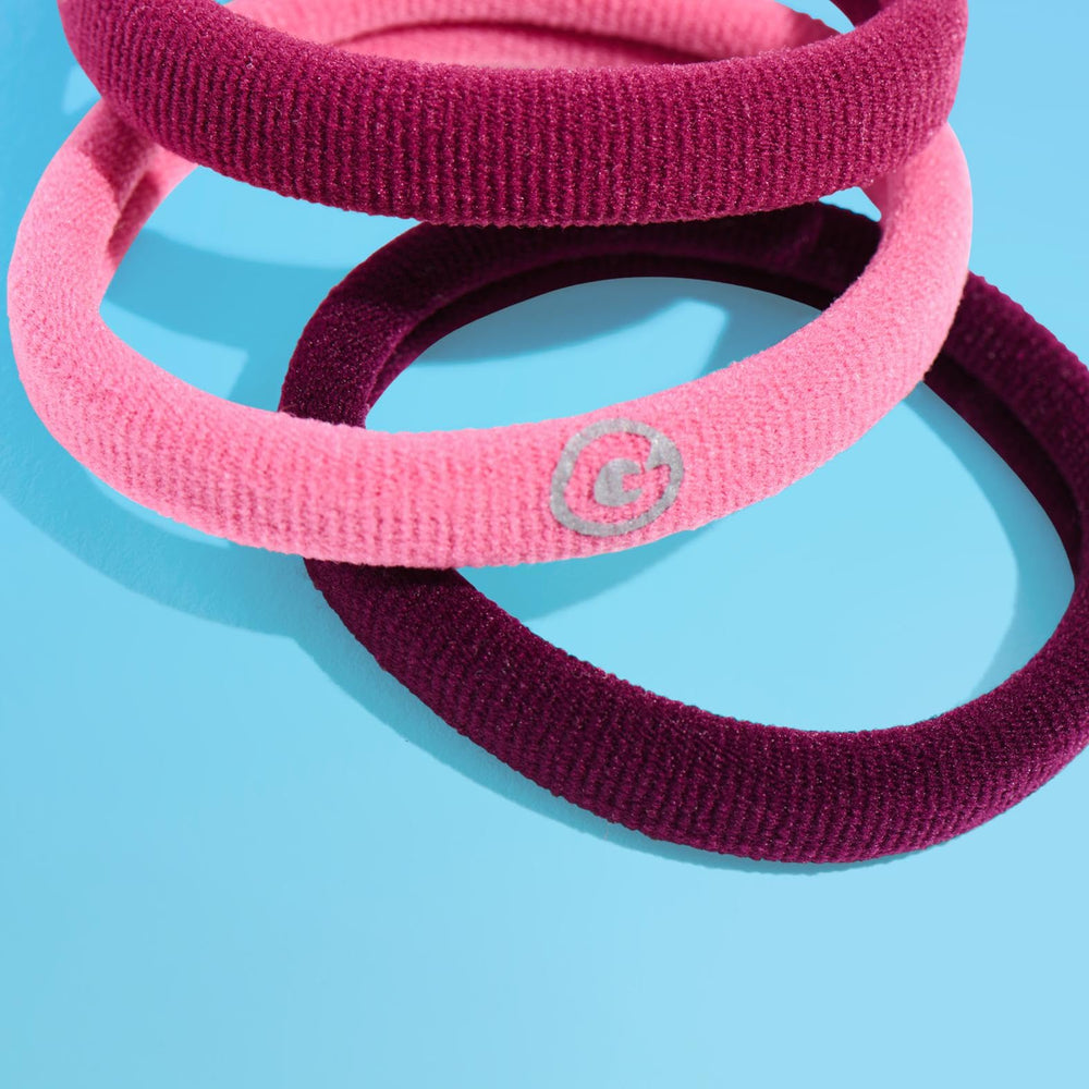 GIMME hair tie in hand to show medium size and easy handling