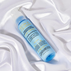 GIOVANNI hands applying serum to hair for easier styling and shine