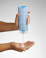GIOVANNI bottle held in hand to show 8.5 oz size and travel-friendly scale