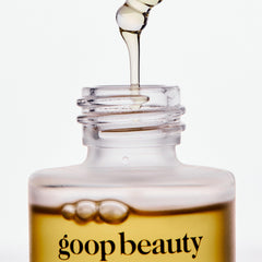 goop nutrient face oil bottle scale with hand illustrating compact one‑ounce size