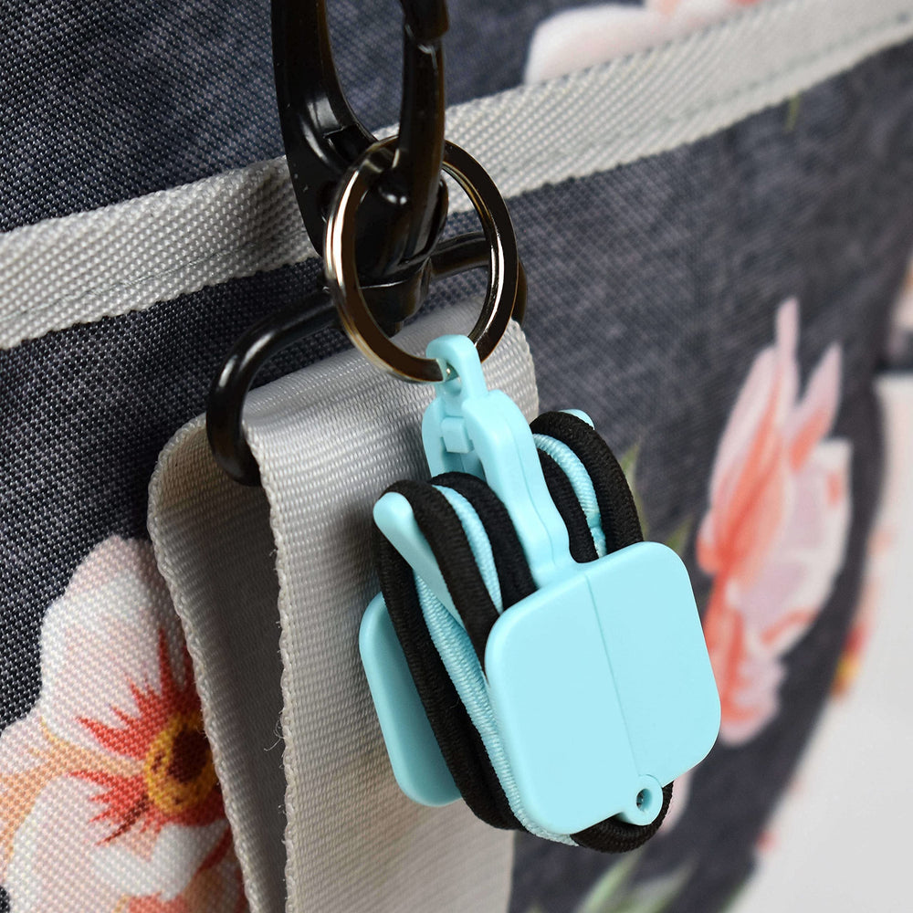 Hair Tie Hub clipped to backpack strap for easy access, Hair Tie Hub travel-ready benefit