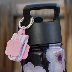 Hair Tie Hub beside keys showing scale and convenient everyday carry