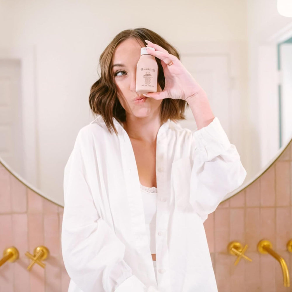 Hairitage on bathroom shelf in lifestyle scene suggesting salon-quality care at home