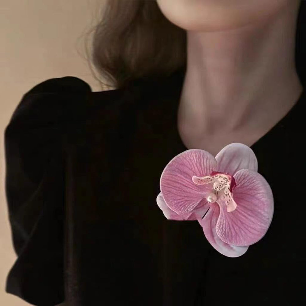 HANSAMU floral hairpin placed in bridal updo adding romantic accent