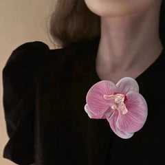 HANSAMU floral hairpin placed in bridal updo adding romantic accent