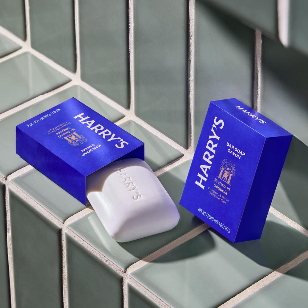 Hand holding Harry's 4 oz bar to show size and portable benefit